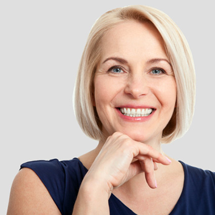 Older woman with a gorgeous smile thanks to our cosmetic services