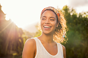 Beautiful Black woman smiling after getting dental implants were placed from Mountain State Oral and Facial Surgery in Charleston, WV Beautiful Black woman smiling after getting dental implants were placed from Mountain State Oral and Facial Surgery in Charleston, WV