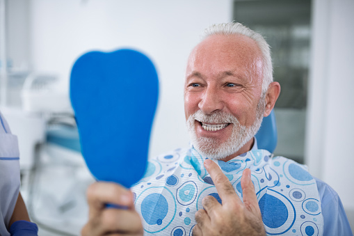 Old man smiling after dental appointment at Mountain State Oral and Facial Surgery in Hurricane, WV