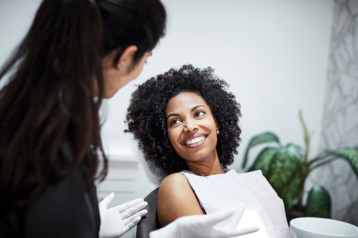 woman speaking with dentist after getting a sinus lift from Mountain State Oral and Facial Surgery in Hurricane, WV woman speaking with dentist after getting a sinus lift from Mountain State Oral and Facial Surgery in Hurricane, WV