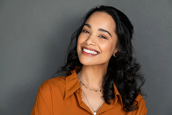 Beautiful Hispanic woman showing off her brilliant teeth and smiling with dental implants from Mountain State Oral and Facial Surgery in Ashland, KY Beautiful Hispanic woman showing off her brilliant teeth and smiling with dental implants from Mountain State Oral and Facial Surgery in Ashland, KY