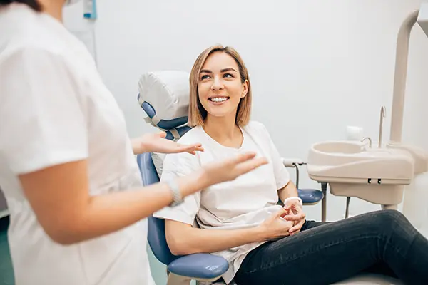 A woman in a dental chair discussing all on 4 with her dentist at Mountain State Oral and Facial Surgery in Charleston, WV