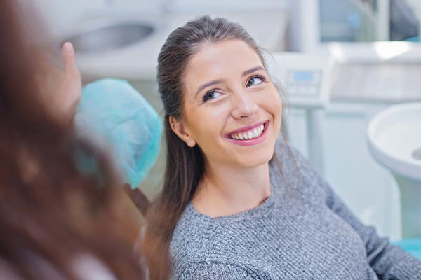 Woman smiling while at dental office from Mountain State Oral and Facial Surgery in Charleston, WV