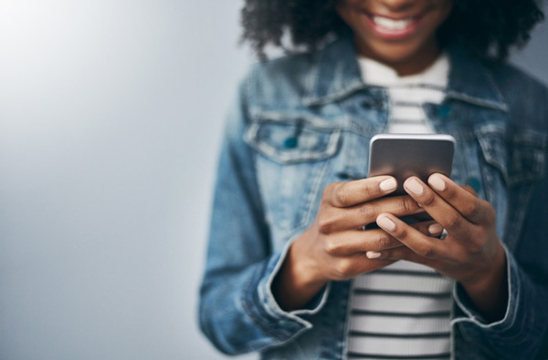 Woman looking at the Mountain State Oral and Facial Surgery website on her phone in West Virginia