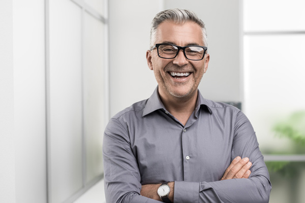 Man smiling with his arms crossed from Mountain State Oral and Facial Surgery in Charleston, WV