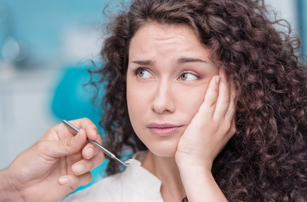 Woman holding cheek due to tooth ache from Mountain State Oral and Facial Surgery in Vinton, VA Woman holding cheek due to tooth ache from Mountain State Oral and Facial Surgery in Vinton, VA