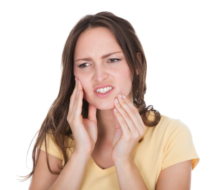 Woman with mouth pain clutching jaw
